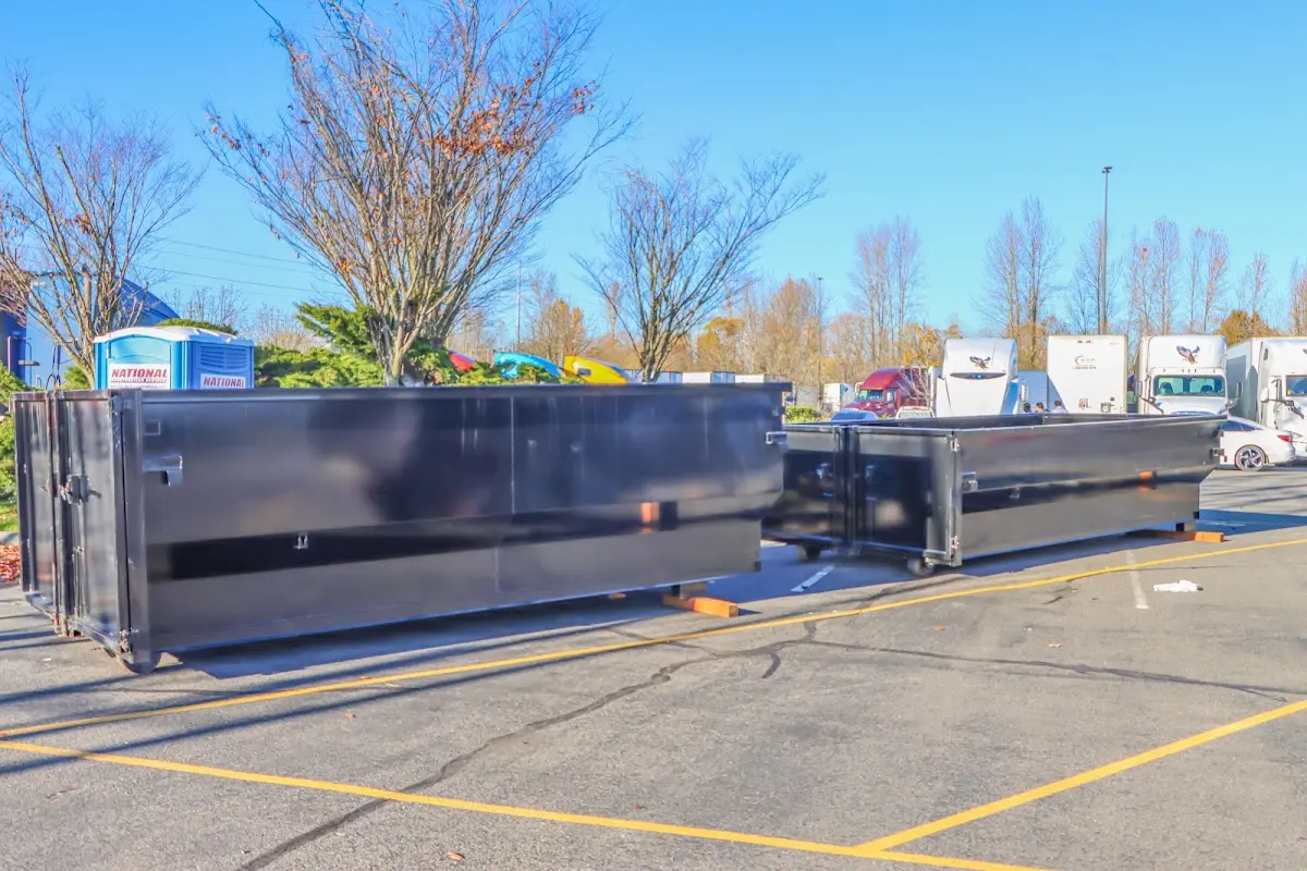 Professional dumpster rental service with roll-off container on residential driveway in Irvington